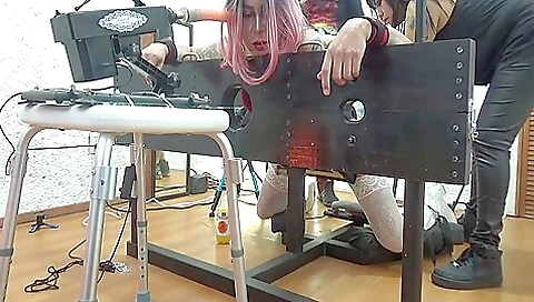 A naughty girl rides a dildo in a kinky bondage scene